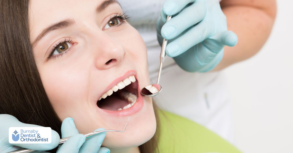 A dentist checking a woman's teeth during a routine dental checkup.