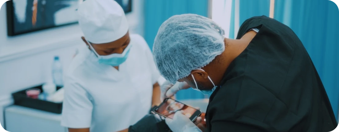 Dental surgeon and assistant performing a procedure in a clinic