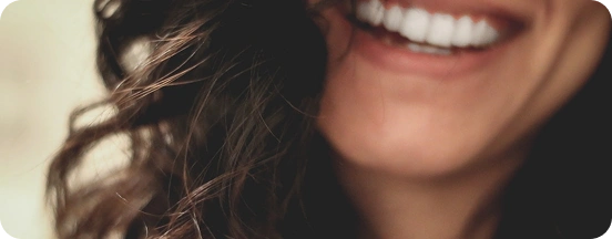 A woman smiling after having done the preventive dental care
