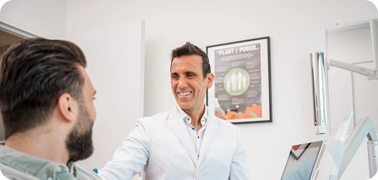 Male dentist smiling in his clinic.