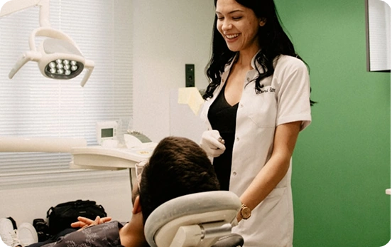 Female dentist talking to a patient during a dental checkup in the clinic